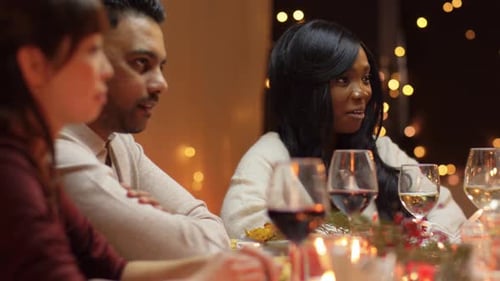 Friends Enjoying Festive Dinner Party at Christmas