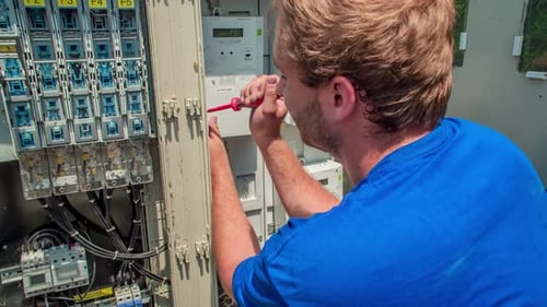 Electrician Working on Electrical Wiring in Fuse Box
