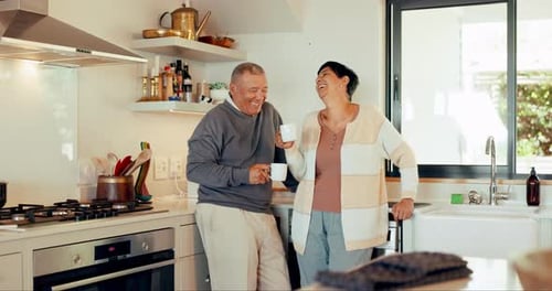 Senior Couple Embracing in Sunny Kitchen