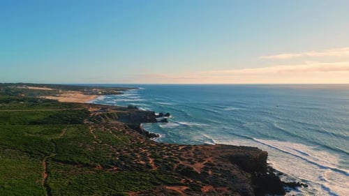 Powerful blue ocean waves splashing rocky picturesque coastline super slow motion