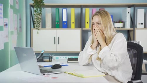Shocked Woman Working at Computer in Office