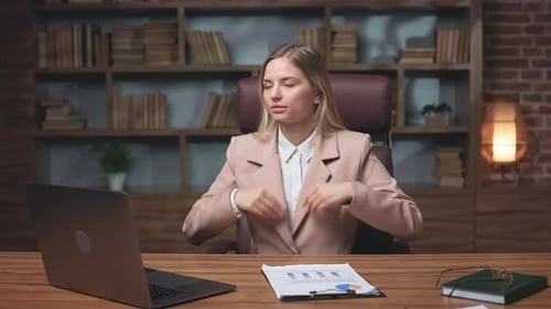 Woman Meditating at Desk in Office Environment