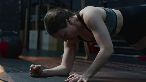 Woman Doing Plank Exercise in Gym