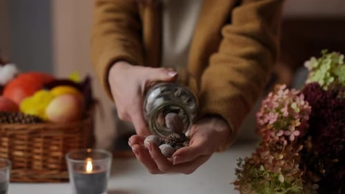 Person Decorating for Fall with Acorns and Nuts