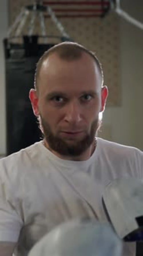 Boxer punching air in gym close up. Motivated man practicing punches.