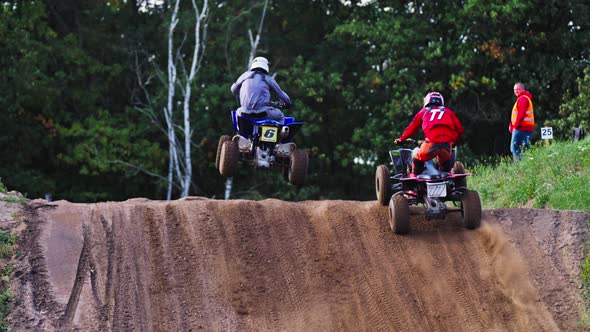 Quad Bikers Racing Competition - Two Quad Racers Jumping Over Hill ...