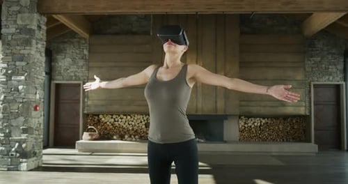 Woman Wearing VR Headset With Arms Outstretched