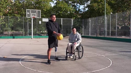 Man with Prosthetic Leg and Woman on Basketball Court