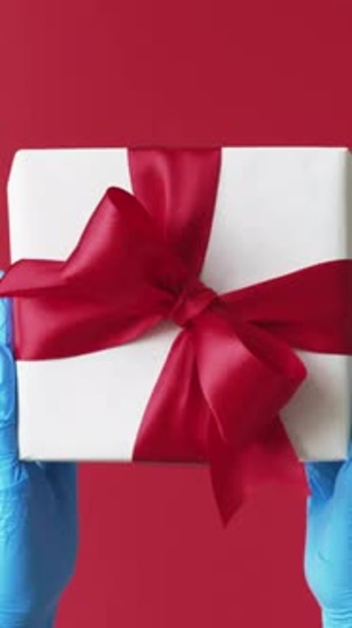 Gift Box Presented with Surgical Glove on Red