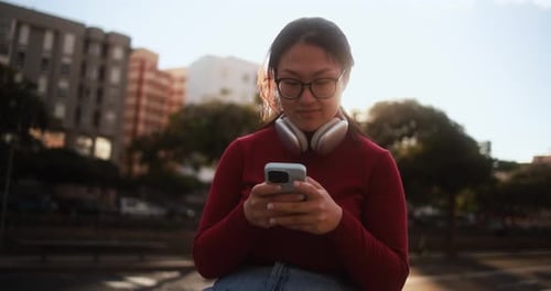 Woman Using Smartphone in Urban Setting