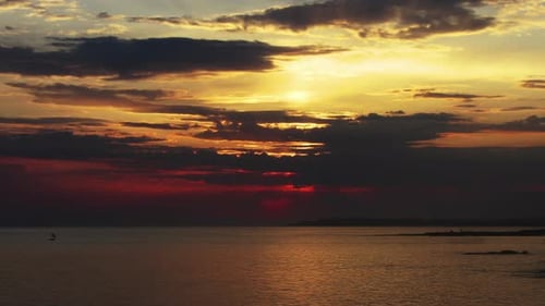 Sunset Sun and Clouds Over Sea