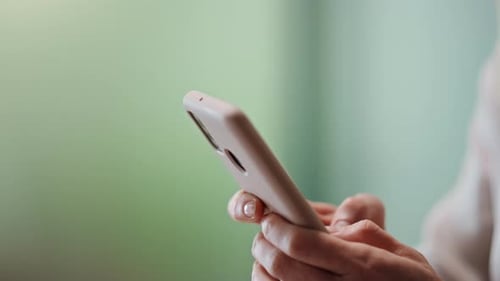 Woman Holding and Using Smartphone, Close Up