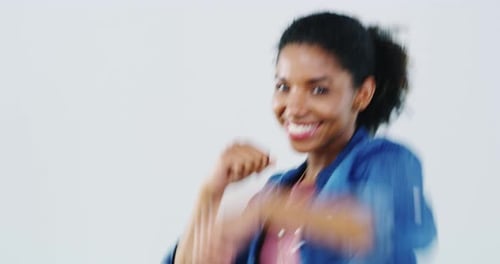 Smile, dance and face of black woman in celebration in studio isolated on a white background