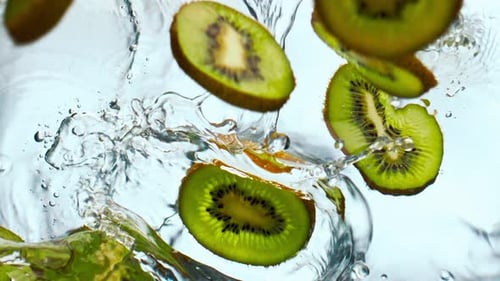 Slices Kiwi Falling Water in Super Slow Motion Close Up