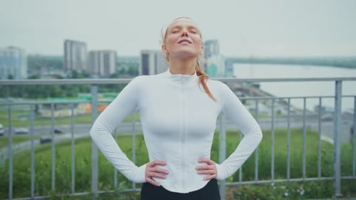 Auburn Haired Woman Enjoys Fresh Air in City