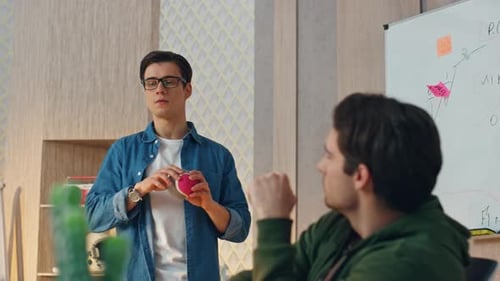 Relaxed Freelancers Tossing Ball Talking at Office Closeup Partners Discussing