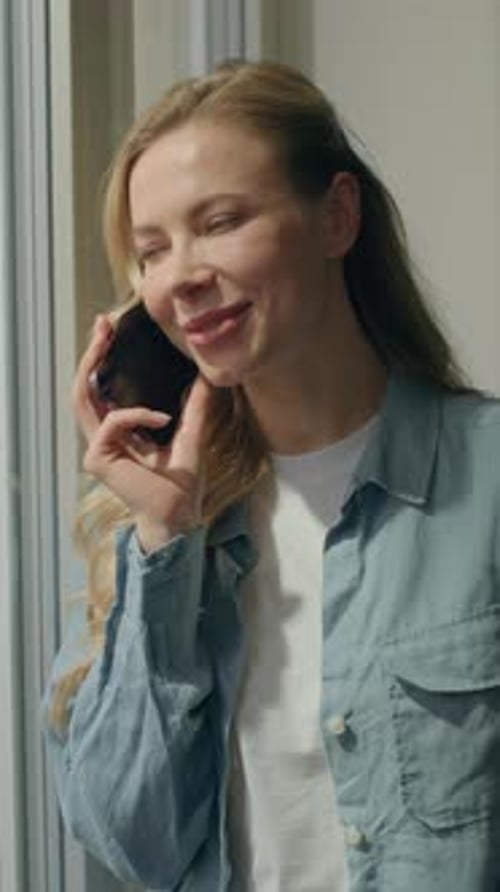 Woman Talking on Mobile Phone in Bright Home