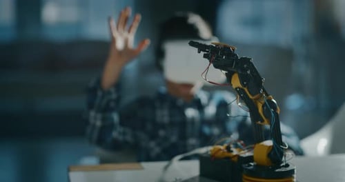 Child Using VR Headset with Robotic Arm