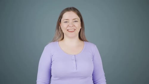 Friendly Woman Smiling Portrait in Front of Gray Background
