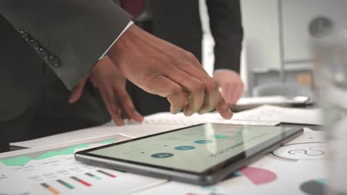 Business Partners Using Digital Tablet while Working on Project