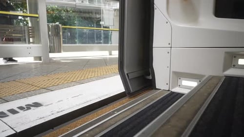 Subway doors closing at outdoor station platform
