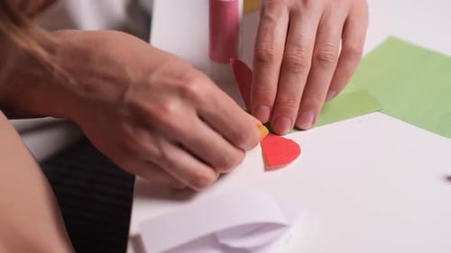 Mother and Child Assembling a Colorful Paper Flower Greeting Card