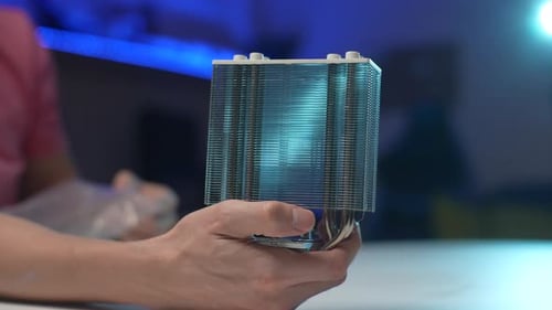 Closeup Side View of Unrecognizable Man Takes PC CPU Air Cooling System Radiator Out of Bag and