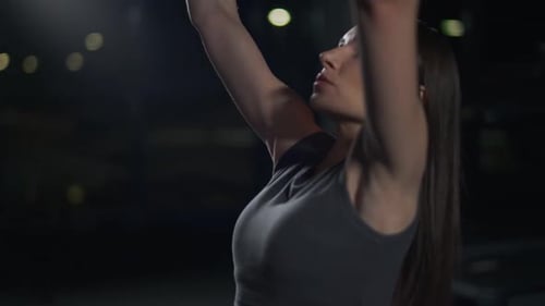 Sporty Woman in the Gym Lifting Blocks on Gym Machine Strength Training on Block Device and Gym