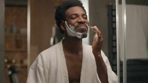 Man Applying Shaving Cream in Bathroom
