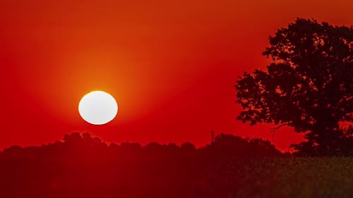 Sunrise rising sun time lapse red golden big bright sun moving in the sky
