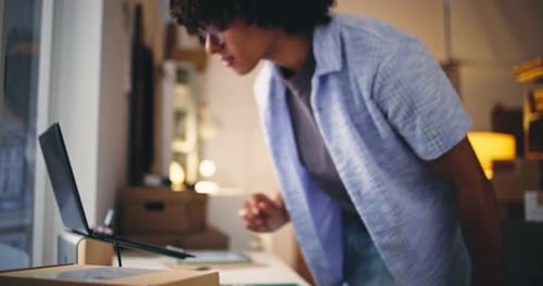 Young Man Scanning Package Barcode at Home Office