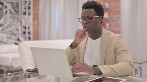 Adult Man Working on Laptop Coughing