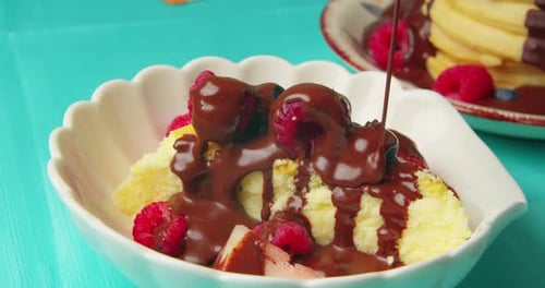 Piece of Cake with Strawberries is Poured with Chocolate Sauce