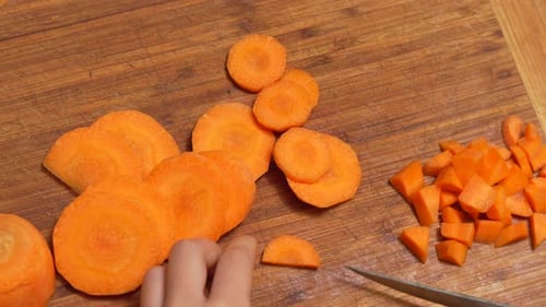 Chopping Carrots on a Wooden Cutting Board