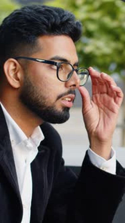 Stressed Man in Blazer with Headache Outside