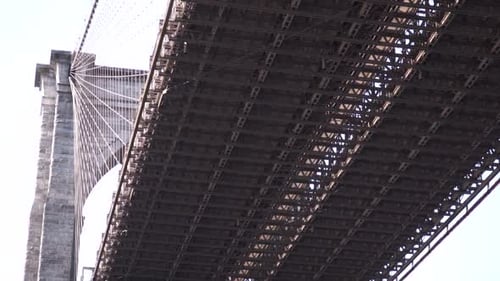 Iconic Brooklyn Bridge extreme close up starting from underneath the Brooklyn Bridge tilting up in s