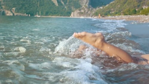 Child Feet Splashing Water at Beach