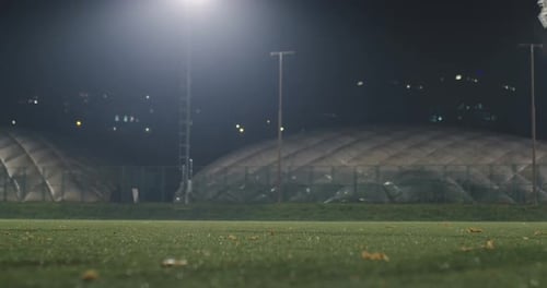 American football players in action at night game time on the field