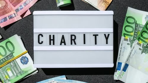 Zoom in Out Lightbox Board with Word CHARITY in Black Letters Around Euro Banknotes