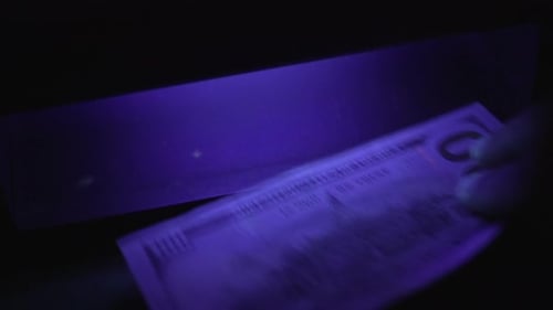 Checking Money with UV Light for Security Features