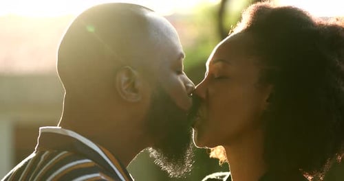 Happy Couple Sharing Kiss in the Warm Sunlight