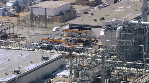 Aerial view of flames and smoke at southern California oil refinery stack
