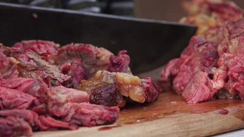 Cooked Pink Meat Sliced on a Cutting Board