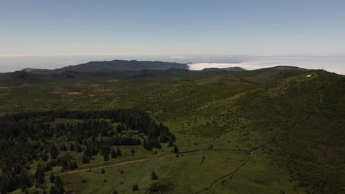 Aerial view of the green mountains in madeira island. Drone rotating to the left revealing the