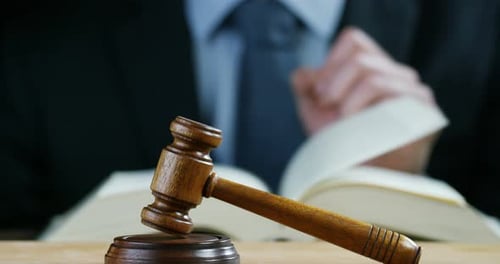 Gavel on Table Next to Law Book