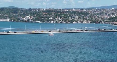 Istanbul Bosphorus Bridge and City Skyline in Background with Turkish Flag at Beautiful Sunset