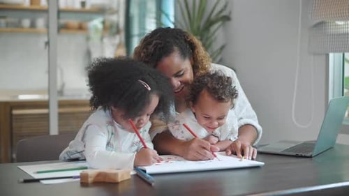 African American mother playing with her daughters in home