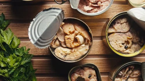 Opening Metal Cans with Canned Fish and Pate on Table Top View Canned Salmon and Tuna Macro Canning