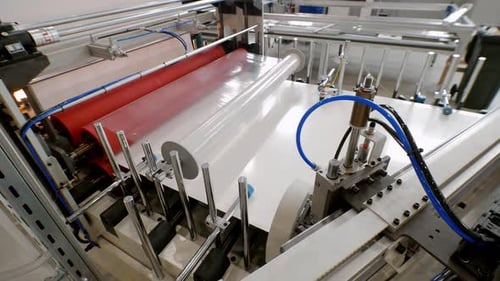 During the Final Stage of Manufacturing Furniture Large Metal Sheets are Covered with Paper and Then
