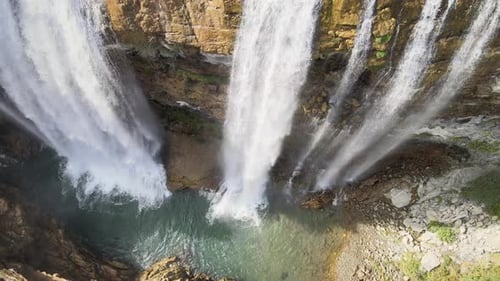 Aerial View of Majestic Waterfall Cascading Down